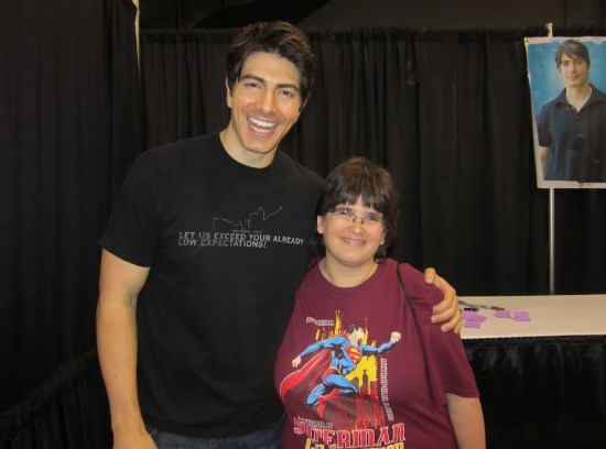 Anne with Brandon Routh, both smiling. He's over a foot taller than her.