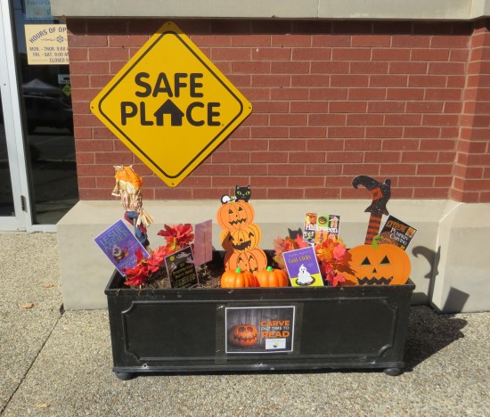bin of Halloween recommended reading in front of the library