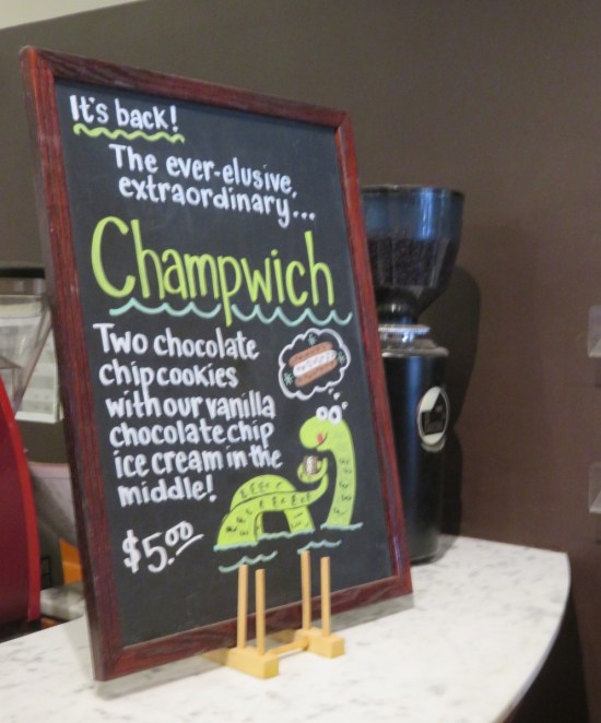 Champwich chalkboard sign at the chocolate shop with a drawing of Champy the monster