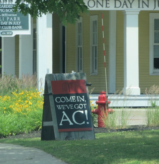 Chalkboard sign reading "Come In We've Got AC!"