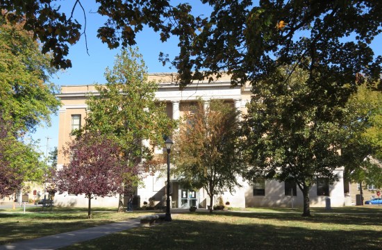 The three-story Harrison County Courthouse in Corydon, with white columns and brick walls.