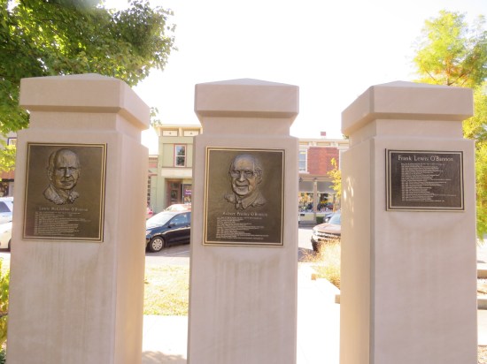 Three more columns with plaques listing O'Bannon family highlights.