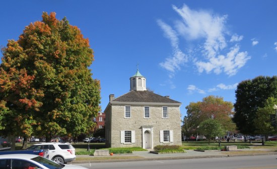 The Old State Capitol Building in Corydon, Indiana, surrounded by trees in autumn.