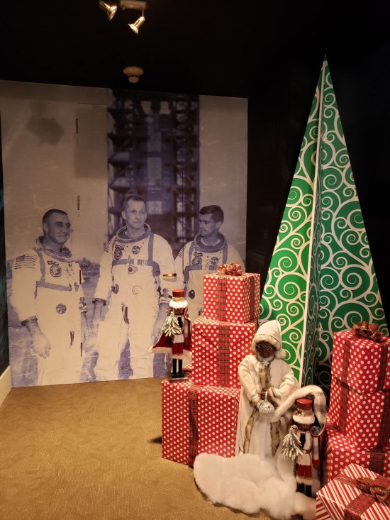 Photo of the Apollo 1 crew behind some Christmas decor.