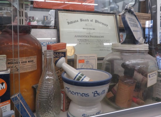 Thomas Butt's Apprentice Pharmacist certificate and his personalized mortar and pestle.