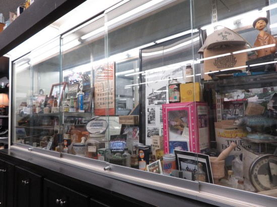 Assorted Corydon relics in a glass cabinet.