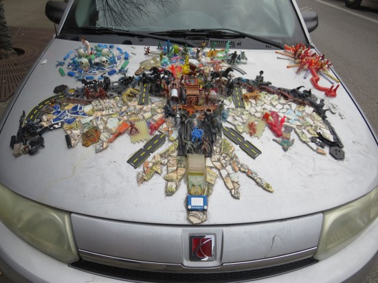 car hood with toys glued to it.