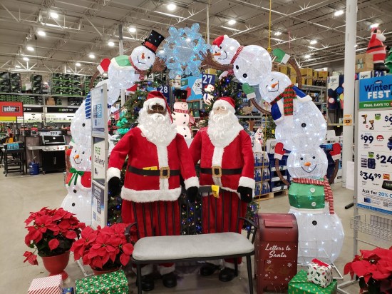 Two Santa mannequins, one white and one Black, on display at our local Lowe's store.