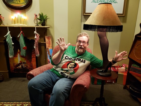 me doing jazz hands next to "A Christmas Story" replica leg lamp.