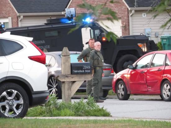 Two cops part of a task force, staring directly into Anne's camera.