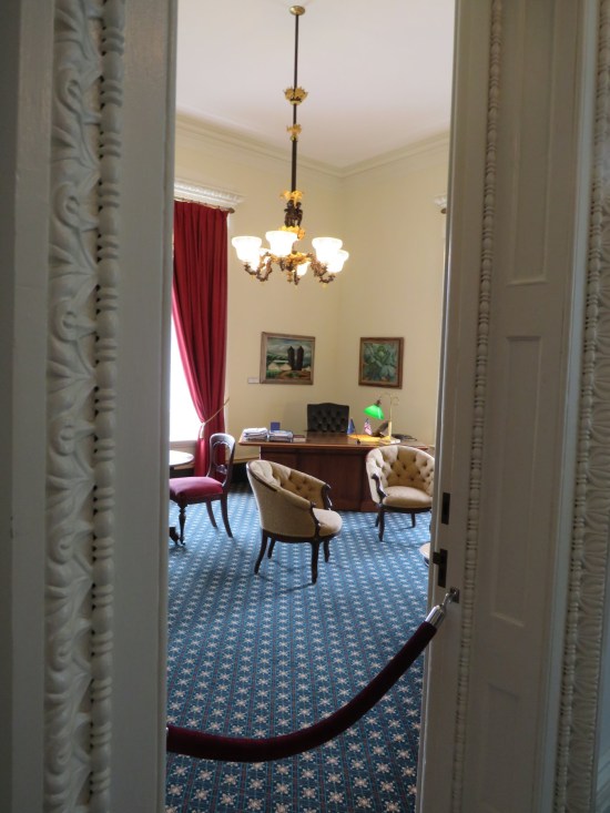 Looking through the open doors of a government office, a velvet rope preventing us from walking in.