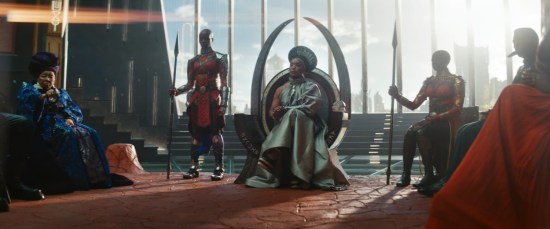 Angela Bassett as Queen Ramonda surrounded by Okoye and Wakanda councilpeople.