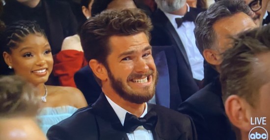 Andrew Garfield in the Oscars audience, bravely mugging for the cameras after Jimmy Kimmel has tried dragging him into one of his jokes.
