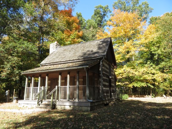 A log cabin in the woods with some (unseen) history to it.