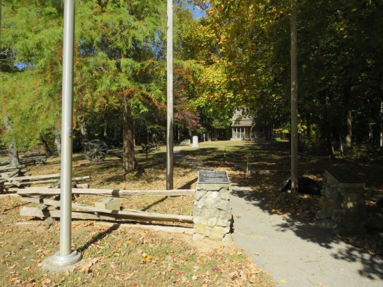 The open space where the cabin and mementos are kept, amid the forest, which is all autumn colors.
