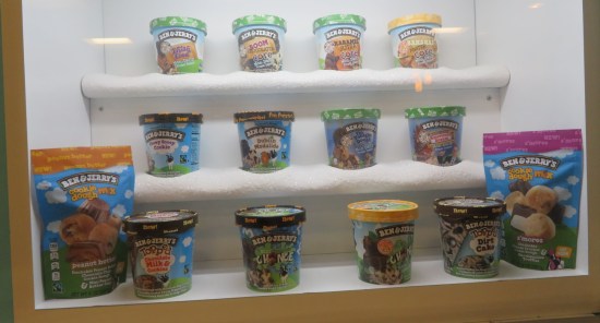 A dozen Ben & Jerry's pints untouchable in a display case.