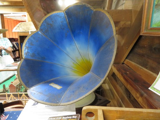 The bell of a blue victrola, painted to look like a flower.