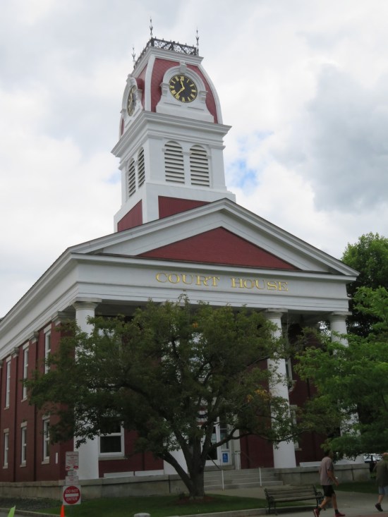 A courthouse with a tall white spire.