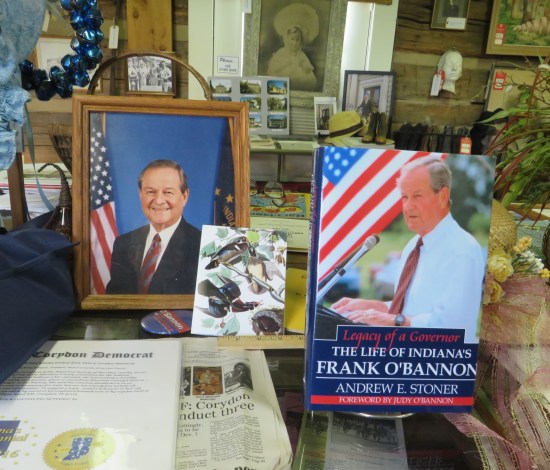 Shelved items bearing photos of Frank O'Bannon.