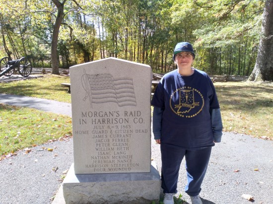 Anne standing next to a monument listing the names of eight Home Guard fatalities and mentioning "four wounded".