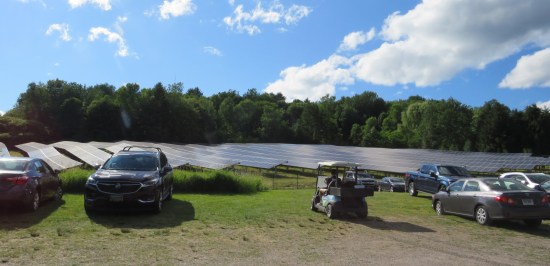 A large field next to the parking lot, covered in solar panels.