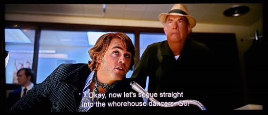 Dace Montgomery as director Steve Binder in Elvis, instructing his stage manager by desk microphone to "send in the whorehouse dancers." 