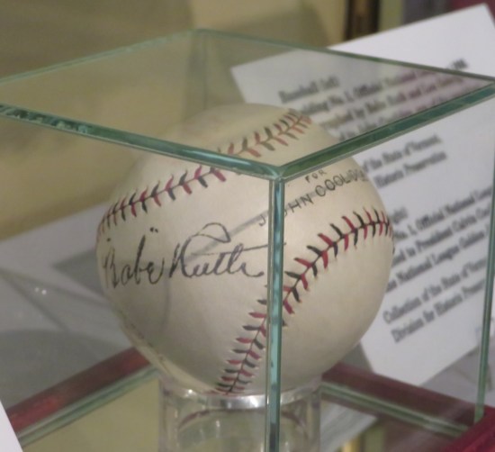 A Babe Ruth autographed baseball in a glass case