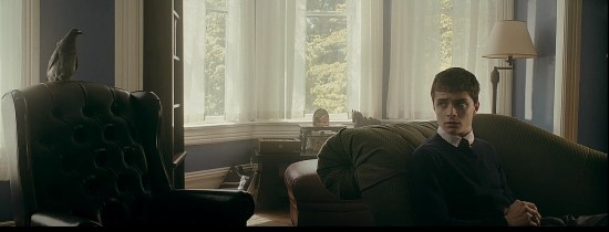 A teen boy on a psychiatrist's couch looks askance at the imaginary bird doctor he's talking to.