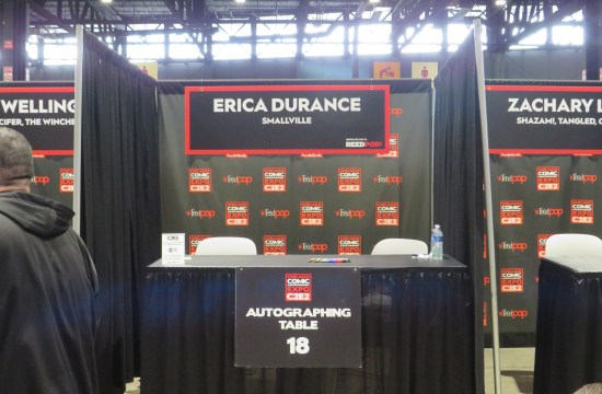 Erica Durance's C2E2 table with just markers, a bottled water, and a tiny sign about payment options.