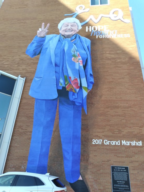 Eva Mozes Kor writ very large on a brick wall.