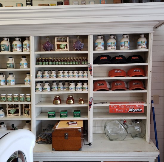 Store shelves lined with lots of stuff as if it's in business.