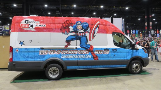 A red, white and blue van with the Graham Crackers Comic Books logo painted on the side, plus a blow-up of a classic Jack Kirby drawing of Captain America.