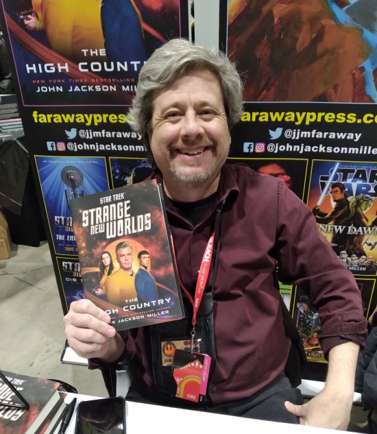 John Jackson Miller holding up a copy of Star Trek: Strange New Worlds: The High Country!