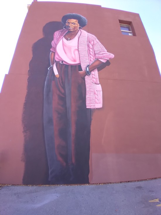 Mari Evans mural on brick, very tall
