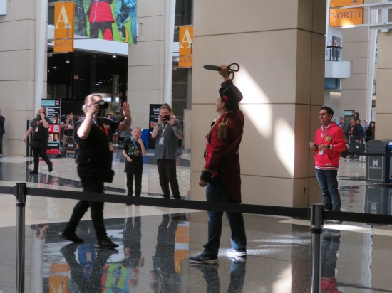 The Mayor of C2E2 holds his big novelty scissors aloft for some guy with a video camera.