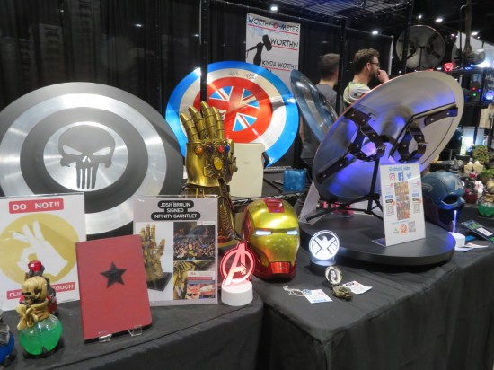 Replicas of various superhero movie props, such as Captain America shield and an Infinity Gauntlet.