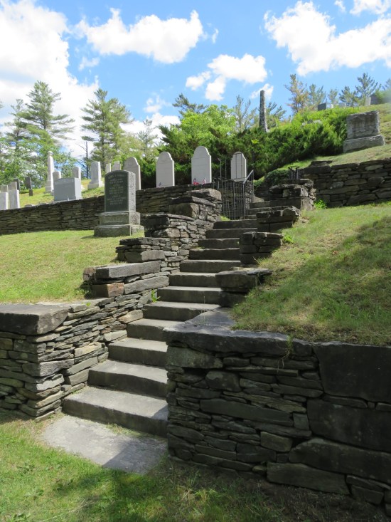 A stone staircase up the cemetery hillside. Coolidges are on the left at the first level up.