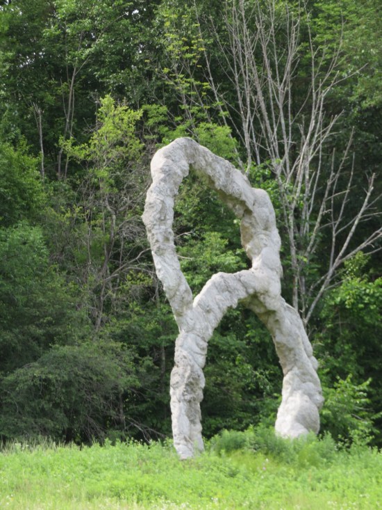 A big marble number 8 standing in a field.