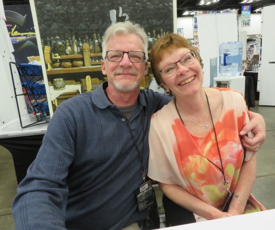 Gerhard and his wife smiling at their ICC table.