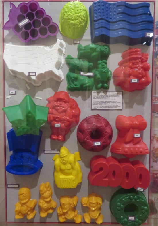 Some plastic Jell-O molds in ugly toy colors, hung in a smaller display.