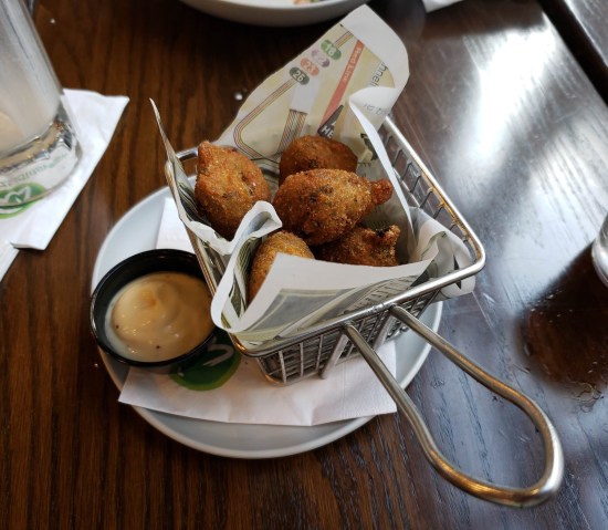 A cup of fried dough balls. See caption.