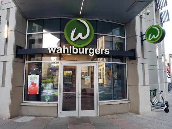 The Wahlburgers entrance, with a few scooters standing unused at one side.