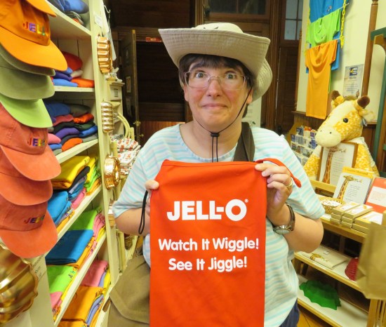 Anne making a face while holding up a T-shirt with the old Jell-O slogan "Watch It Wiggle! See It Jiggle!"