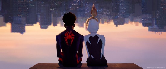 Miles Morales and Spider-Gwen sitting upside-down on the underside of a ledge, looking out on New York City.