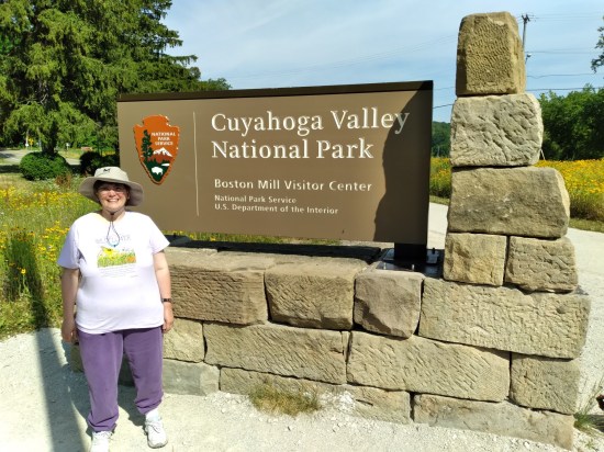 Anne smiling and standing in front of a large Cuyahoga Valley National Park sign.