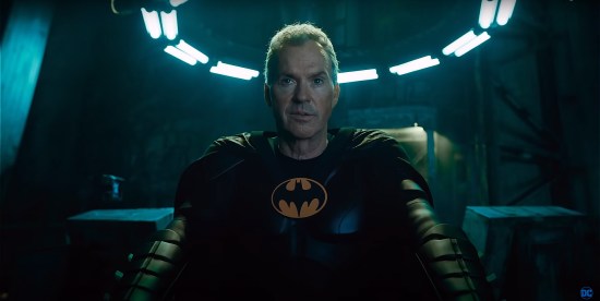Michael Keaton as Batman in the Bat-Cave, with his costume on except no mask.