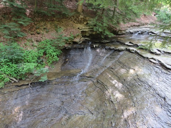 One last weak waterfall trickling down sheer rocks slanted at 45 degrees.