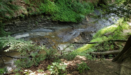 A short, not very robust waterfall, shot horizontally so it looks like a creek.