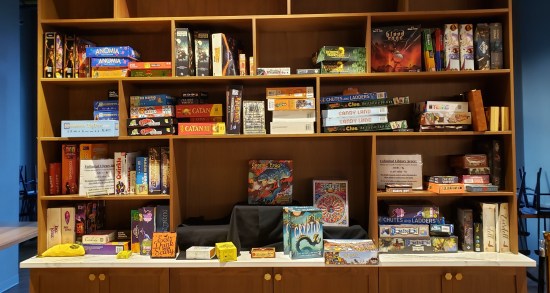 A cabinet filled with dozens of board games for various age groups.