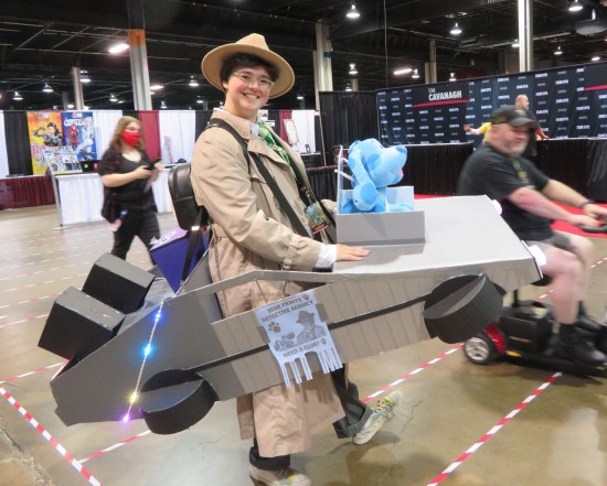 Costume: Steve from "Blue's Clues" in a detective outfit, wearing a large cardboard DeLorean around her from twin shoulder straps. A plush Blue dog sits on the dashboard.